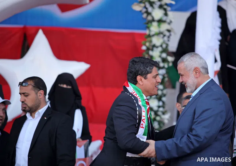Senior Hamas leader Ismail Haniyeh attends a mass wedding ceremony in Gaza City, on May 31, 2015. Nearly 2000 Palestinian couples were married in a ceremony funded by the Turkish government and supported by the Hamas mov...