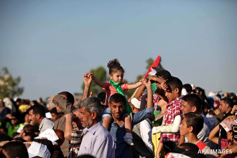 Palestinians attend a a mass wedding ceremony in Gaza City, on May 31, 2015. Nearly 2000 Palestinian couples were married in a ceremony funded by the Turkish government and supported by the Hamas movement. Photo by Ashra...