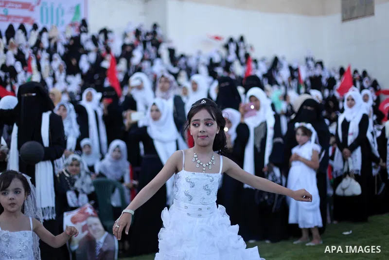 A Palestinian girl attends in a mass wedding ceremony in Gaza City, on May 31, 2015. Nearly 2000 Palestinian couples were married in a ceremony funded by the Turkish government and supported by the Hamas movement. Photo...