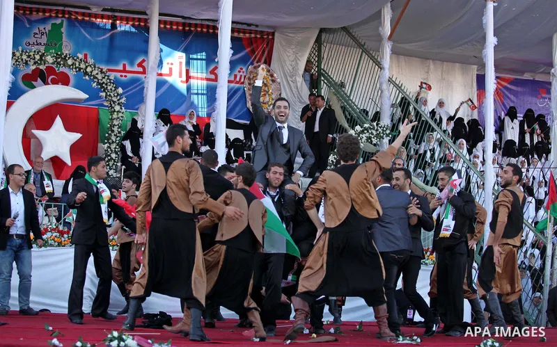 Palestinian grooms celebrate during a mass wedding ceremony in Gaza City, on May 31, 2015. Nearly 2000 Palestinian couples were married in a ceremony funded by the Turkish government and supported by the Hamas movement....