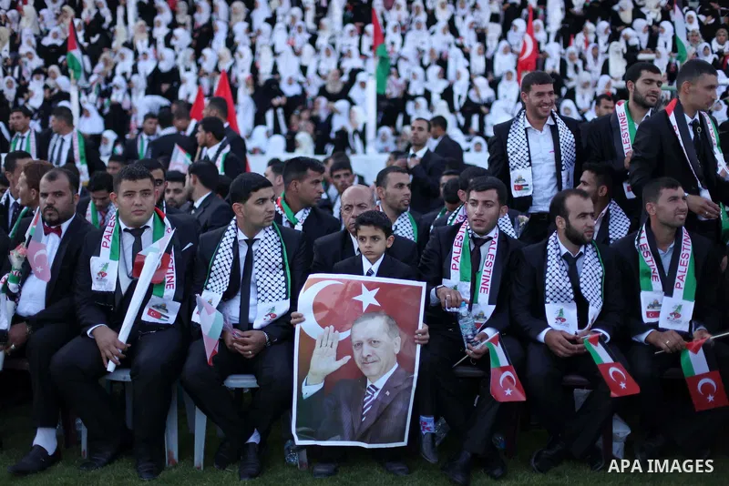 Palestinian grooms take part in a mass wedding ceremony in Gaza City, on May 31, 2015. Nearly 2000 Palestinian couples were married in a ceremony funded by the Turkish government and supported by the Hamas movement. Phot...