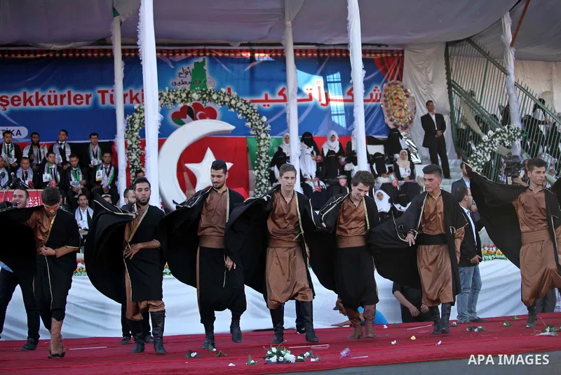 Palestinian grooms celebrate during a mass wedding ceremony in Gaza City, on May 31, 2015. Nearly 2000 Palestinian couples were married in a ceremony funded by the Turkish government and supported by the Hamas movement....