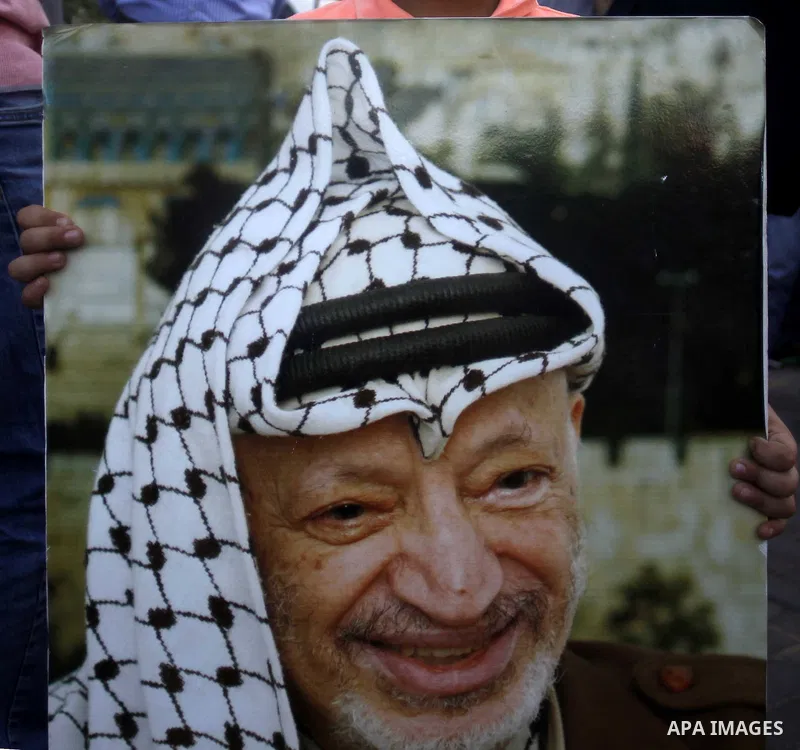 Palestinians take part in a memorial ceremony marking the 14th anniversary of the death of Faisal al-Husseini, Palestinian Authority's representative for Jerusalem affairs, outside the Orient House, which used to be the...