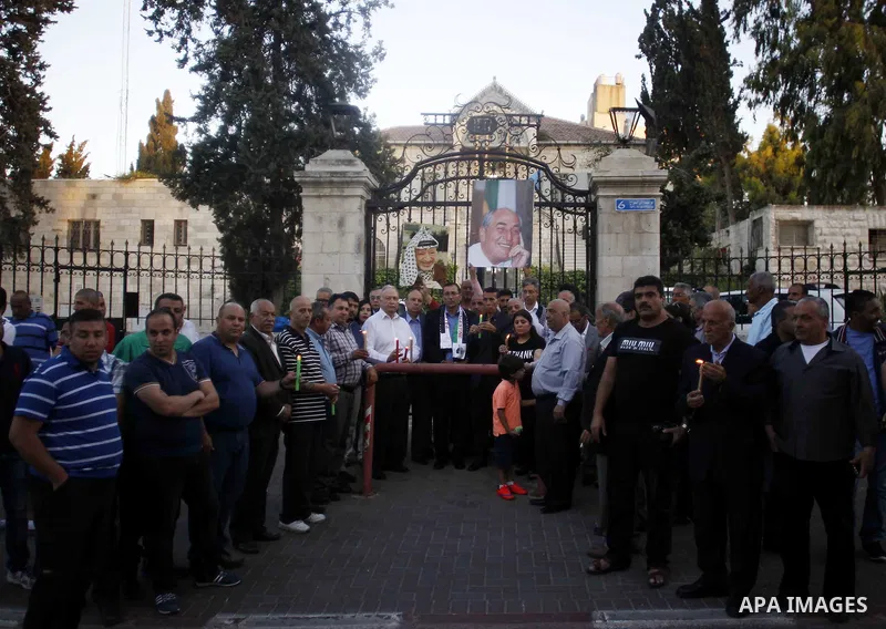 Palestinians take part in a memorial ceremony marking the 14th anniversary of the death of Faisal al-Husseini, Palestinian Authority's representative for Jerusalem affairs, outside the Orient House, which used to be the...