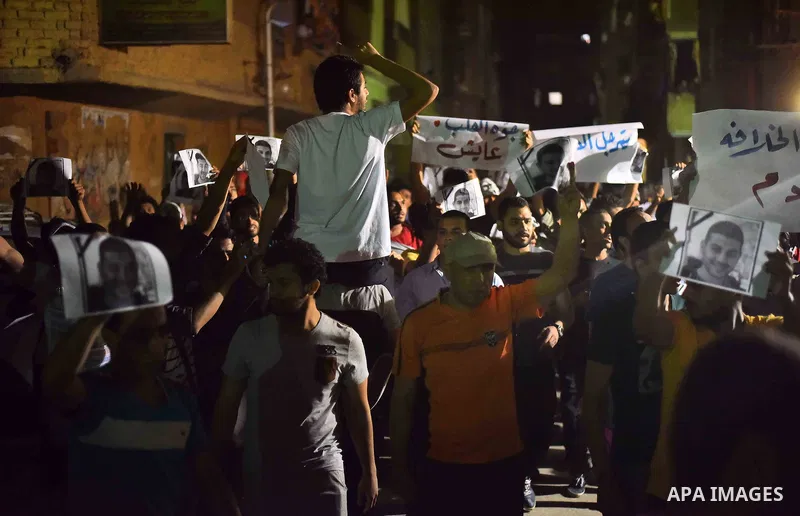 Egyptian youths who support ousted President Mohamed Morsi and the Muslim Brotherhood take part in a protest against killing of their fellow, in Cairo, on May 31, 2015. Photo by Stringer