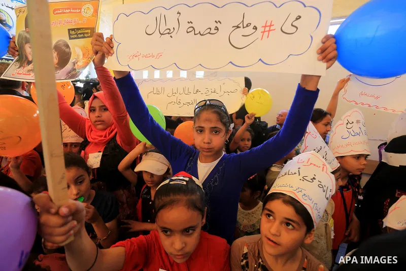 Palestinians hold pictures of prisoners held in Israeli jails, during a protest, in front of Red cross office, in Gaza city, on June 01, 2015. Photo by Mohammed Asad