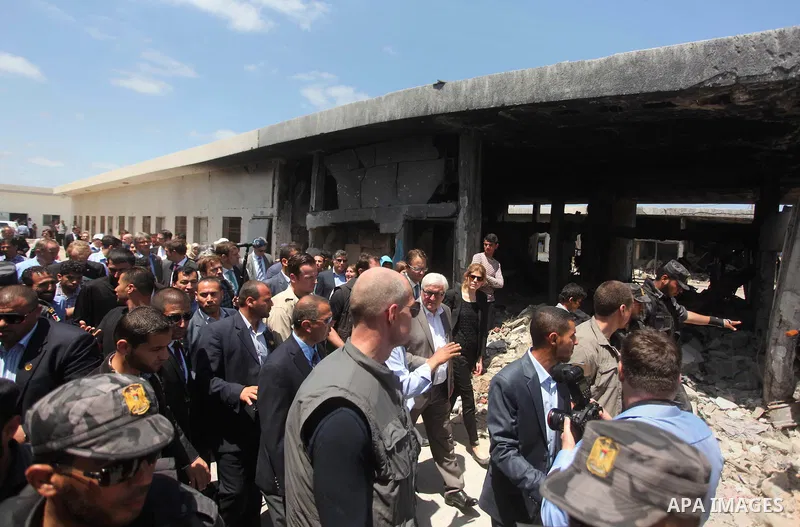 German Foreign Minister Frank-Walter Steinmeier walks next to a destroyed rooms of Palestinian fishermen, damaged during Israeli Hamas conflict of 2014, in Gaza port, during his visit to Gaza City, 01 June 2015. Steinmei...
