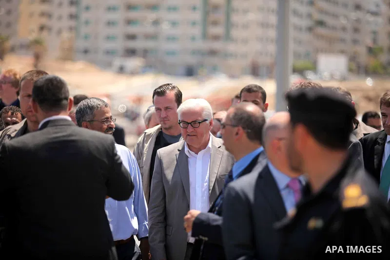 German Foreign Minister Frank-Walter Steinmeier walks next to a destroyed rooms of Palestinian fishermen, damaged during Israeli Hamas conflict of 2014, in Gaza port, during his visit to Gaza City, 01 June 2015. Steinmei...