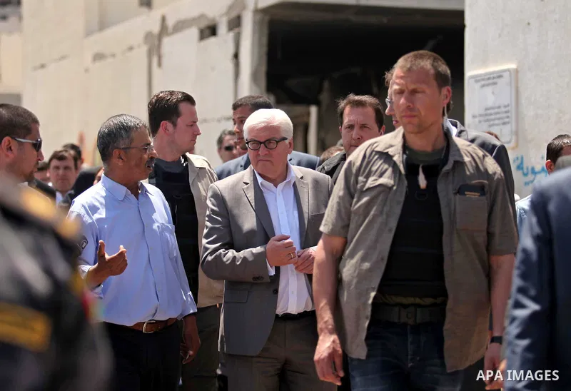 German Foreign Minister Frank-Walter Steinmeier walks next to a destroyed rooms of Palestinian fishermen, damaged during Israeli Hamas conflict of 2014, in Gaza port, during his visit to Gaza City, 01 June 2015. Steinmei...