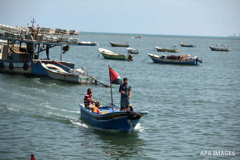 Palestinian fishermen ride their boats during the visit of German Foreign Minister Frank-Walter Steinmeier destroyed rooms of Palestinian fishermen, damaged during Israeli Hamas conflict of 2014, in Gaza port, during his...