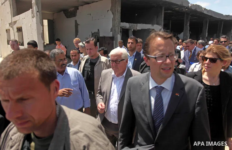 German Foreign Minister Frank-Walter Steinmeier walks next to a destroyed rooms of Palestinian fishermen, damaged during Israeli Hamas conflict of 2014, in Gaza port, during his visit to Gaza City, 01 June 2015. Steinmei...