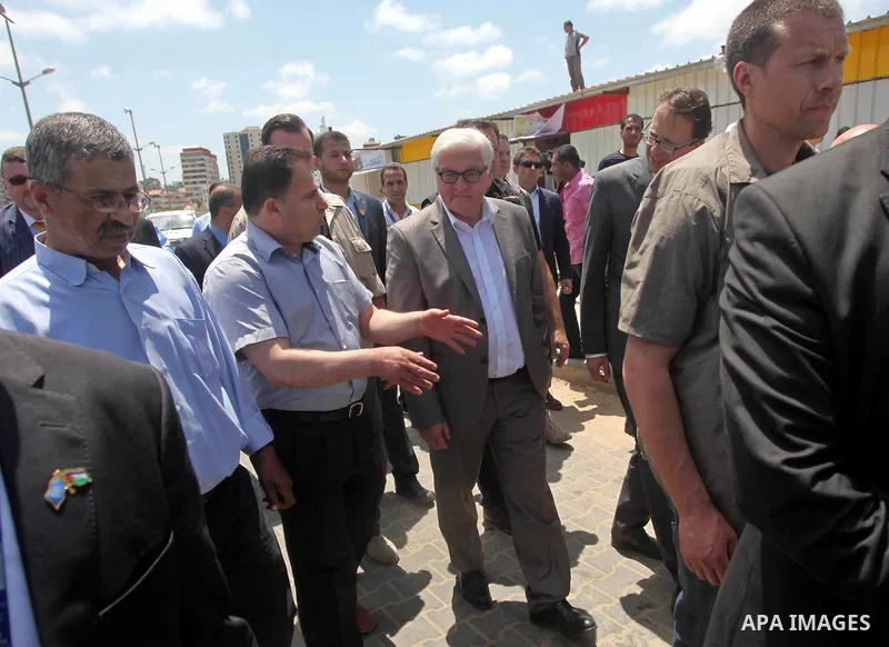 German Foreign Minister Frank-Walter Steinmeier walks next to a destroyed rooms of Palestinian fishermen, damaged during Israeli Hamas conflict of 2014, in Gaza port, during his visit to Gaza City, 01 June 2015. Steinmei...