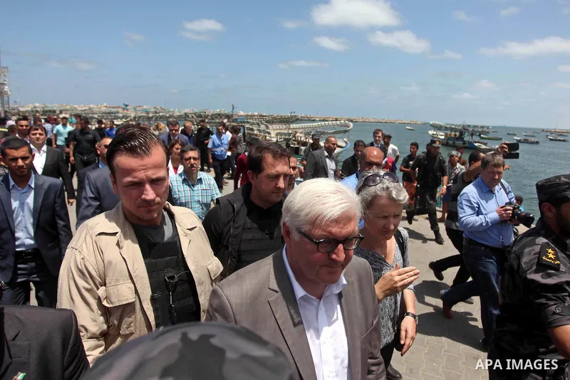 German Foreign Minister Frank-Walter Steinmeier walks next to a destroyed rooms of Palestinian fishermen, damaged during Israeli Hamas conflict of 2014, in Gaza port, during his visit to Gaza City, 01 June 2015. Steinmei...