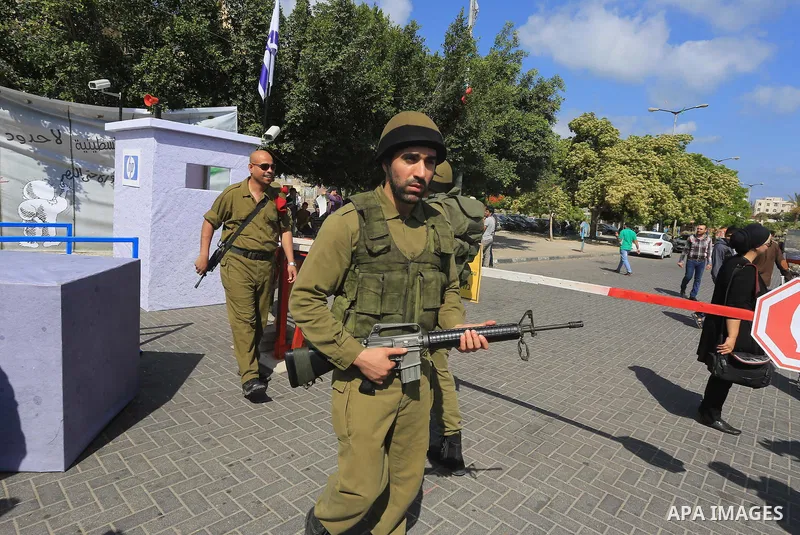 Palestinian youths take part in a theatrical presentation depicts the Israeli checkpoints in the West Bank, in Gaza city on June 2, 2015. Photo by Mohammed Asad