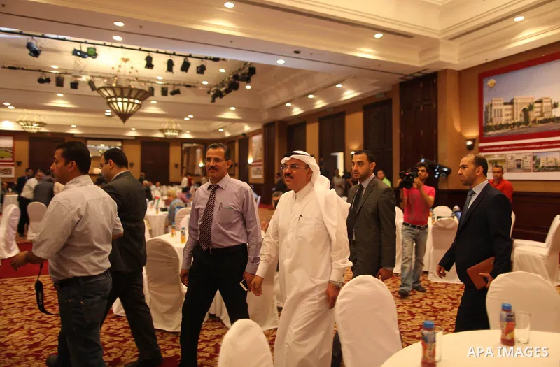 Qatari ambassador Mohammed al-Emadi take part in a signing ceremony of agreement of new projects with Palestinian housing minister Mufeed al-Hasayna in Gaza city on June 2, 2015. Photo by Ashraf Amra