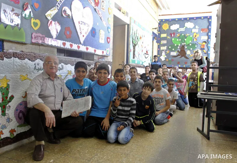 Israeli-Arab schoolchildren sit in the hallway at a school in Jerusalem after sirens sounded across Israel as part of country-wide massive civil defence exercise aimed at preparing the country for air or missile attacks...