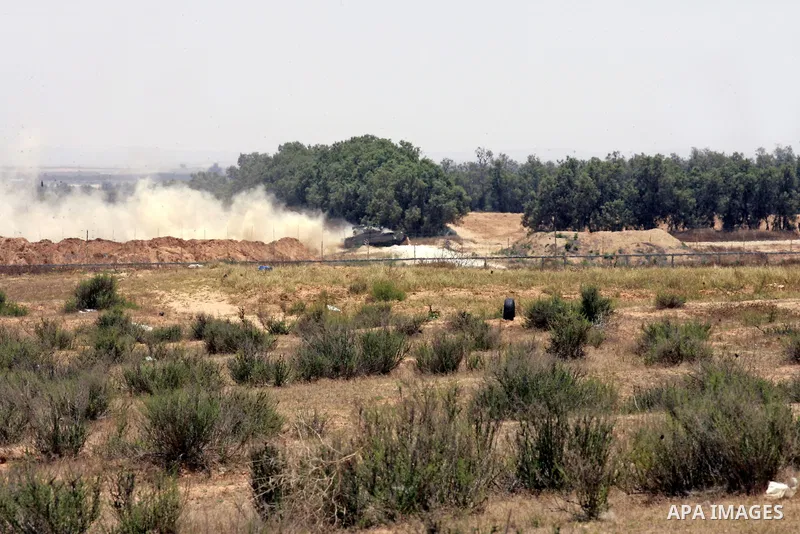 Israeli military bulldozers work along a barbed wire fence that separates Rafah in the southern Gaza Strip and the Israeli border, on June 03, 2015. Israeli troops backed by military vehicles and bulldozers pushed deep i...