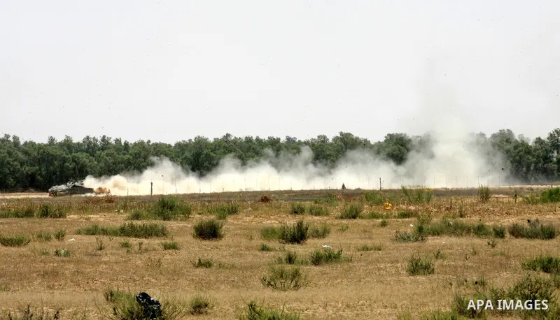 Israeli military bulldozers work along a barbed wire fence that separates Rafah in the southern Gaza Strip and the Israeli border, on June 03, 2015. Israeli troops backed by military vehicles and bulldozers pushed deep i...