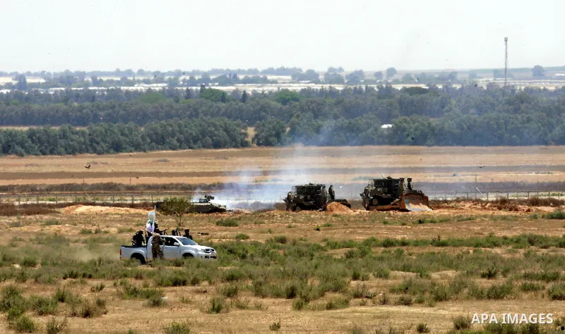 Palestinian militants of the Ezzedine al-Qassam Brigades, Hamas' armed wing, patrol an area 300 meters from the Israeli border with Rafah in the southern Gaza Strip, on June 03, 2015. Israeli troops backed by military ve...