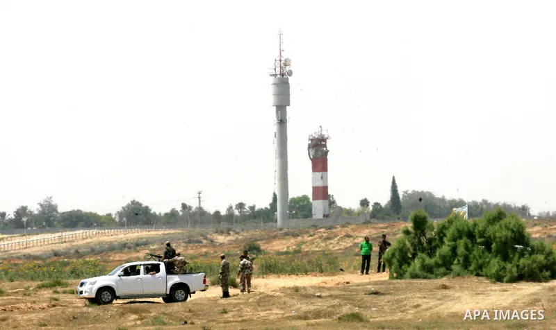 Palestinian militants of the Ezzedine al-Qassam Brigades, Hamas' armed wing, patrol an area 300 meters from the Israeli border with Rafah in the southern Gaza Strip, on June 03, 2015. Israeli troops backed by military ve...