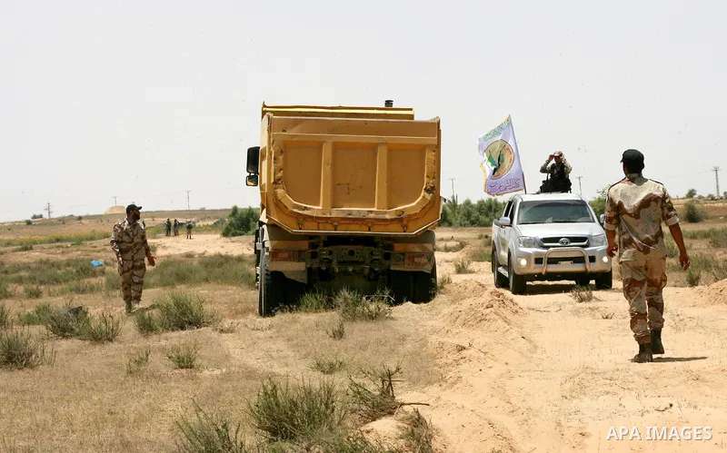 Palestinian militants of the Ezzedine al-Qassam Brigades, Hamas' armed wing, patrol an area 300 meters from the Israeli border with Rafah in the southern Gaza Strip, on June 03, 2015. Israeli troops backed by military ve...
