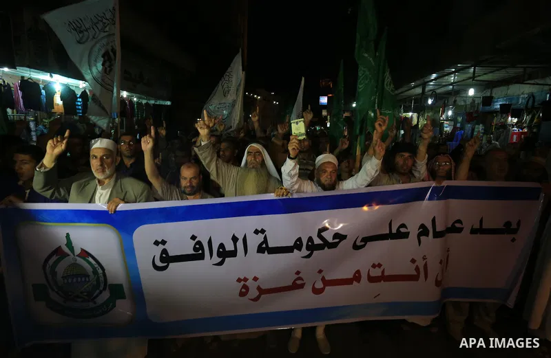 Palestinian Hamas supporters take part in a protest against the Israeli-Egyptian blockade on the Gaza Strip and demanding opening Rafah crossing border, in Khan Younis in the southern Gaza Strip on June 3, 2015. Photo by...