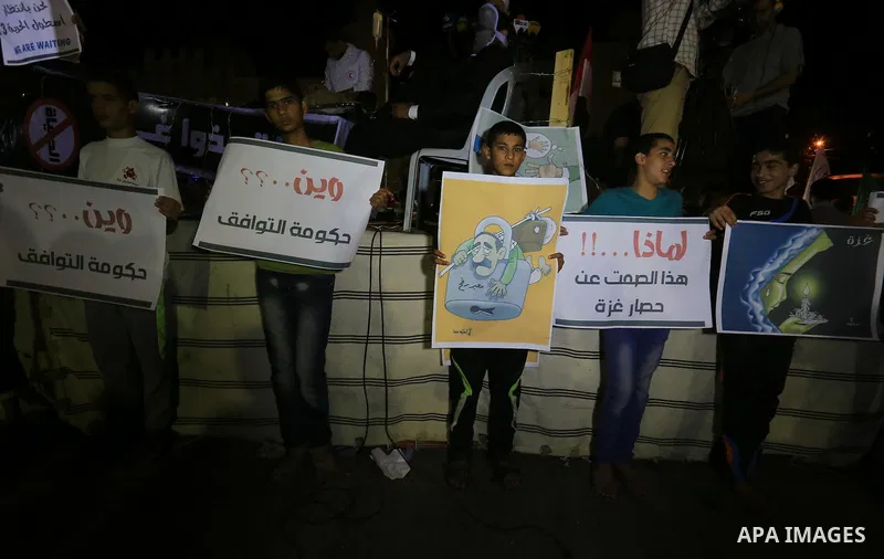Palestinian Hamas supporters take part in a protest against the Israeli-Egyptian blockade on the Gaza Strip and demanding opening Rafah crossing border, in Khan Younis in the southern Gaza Strip on June 3, 2015. Photo by...
