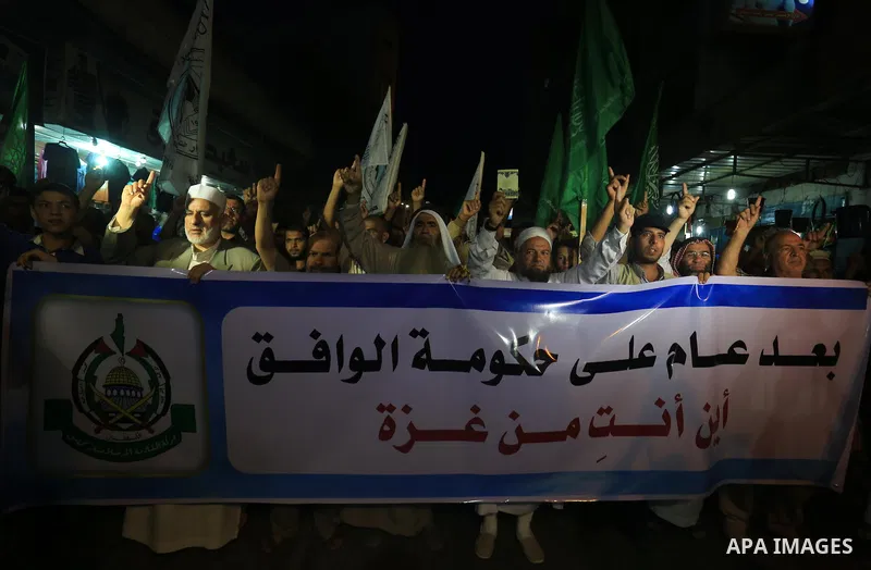 Palestinian Hamas supporters take part in a protest against the Israeli-Egyptian blockade on the Gaza Strip and demanding opening Rafah crossing border, in Khan Younis in the southern Gaza Strip on June 3, 2015. Photo by...
