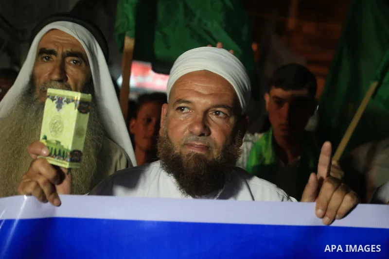 Palestinian Hamas supporters take part in a protest against the Israeli-Egyptian blockade on the Gaza Strip and demanding opening Rafah crossing border, in Khan Younis in the southern Gaza Strip on June 3, 2015. Photo by...
