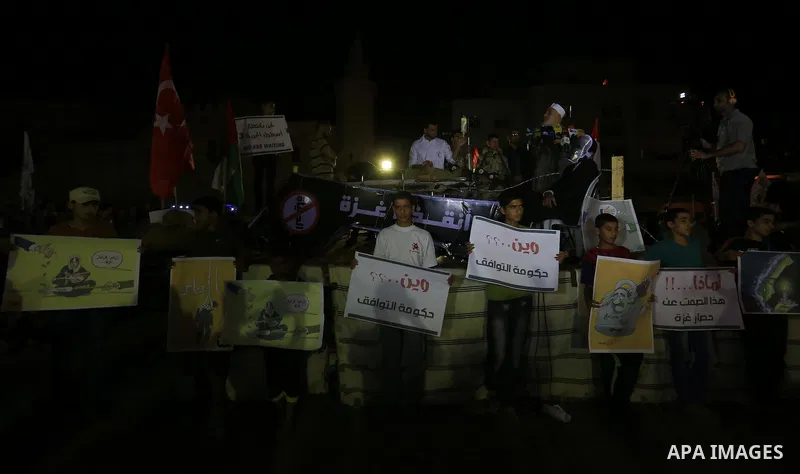 Palestinian Hamas supporters take part in a protest against the Israeli-Egyptian blockade on the Gaza Strip and demanding opening Rafah crossing border, in Khan Younis in the southern Gaza Strip on June 3, 2015. Photo by...