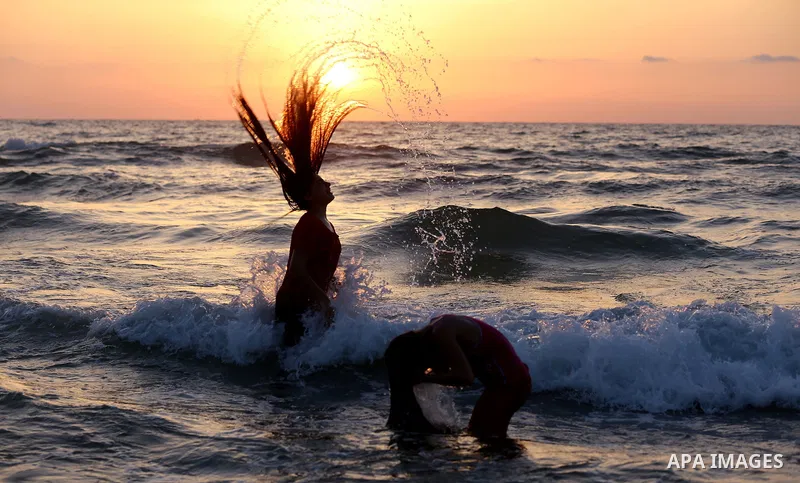 A Palestinian girl swims into the Mediterranean Sea in Gaza City, on June 03, 2015. Photo by Nidal Alwaheidi