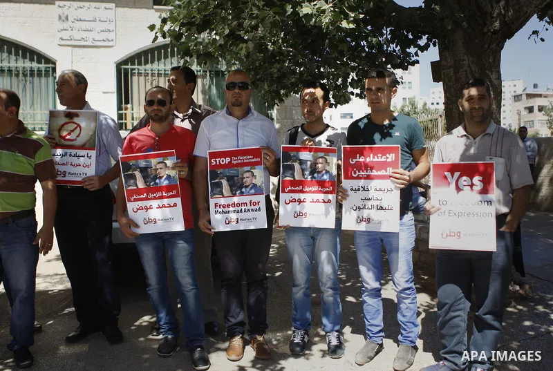 Palestinian journalists take part in a protest against arrest of the Journalist Mohammed Awad by the Palestinian Authority in the West Bank city of Ramallah on June 4, 2015. Photo by Shadi Hatem
