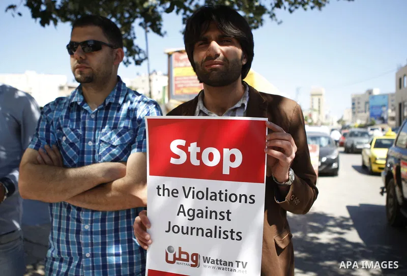 Palestinian journalists take part in a protest against arrest of the Journalist Mohammed Awad by the Palestinian Authority in the West Bank city of Ramallah on June 4, 2015. Photo by Shadi Hatem