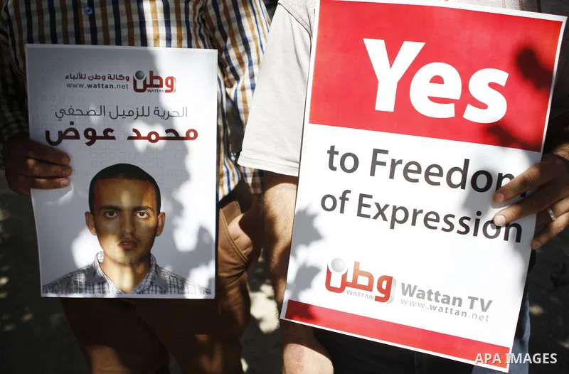 Palestinian journalists take part in a protest against arrest of the Journalist Mohammed Awad by the Palestinian Authority in the West Bank city of Ramallah on June 4, 2015. Photo by Shadi Hatem