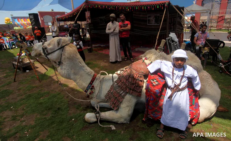 A Palestinian boy takes part in a heritage event during the summer holiday in Gaza city on June 04, 2015. Photo by Ashraf Amra