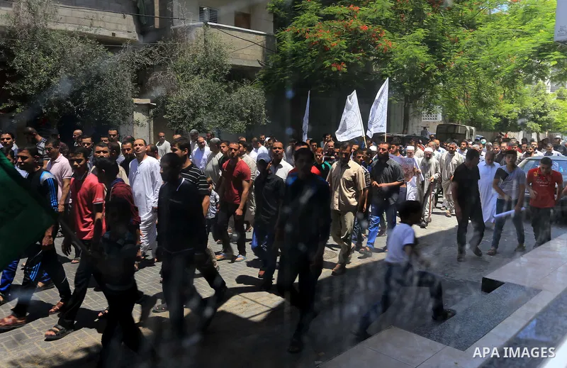 Palestinian Hamas supporters shout slogans during a protest against the United Nations Relief and Works Agency (UNRWA) and the unity government, and calling for an acceleration in the reconstruction of homes destroyed du...