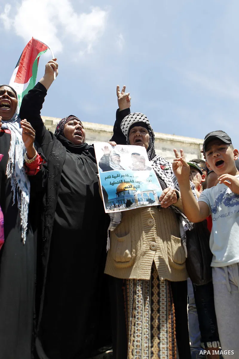 Protestors shout slogans during a demonstration in support of Palestinian Khader Adnan, a senior member of Islamic Jihad who is jailed in Israel without a trial, at the Al-Aqsa mosque in the old city of Jerusalem on June...