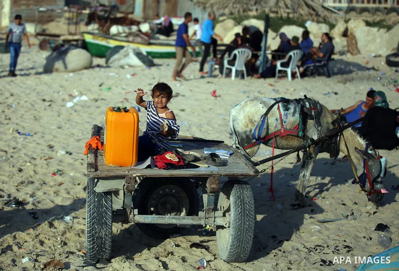 Palestinians enjoy a summer day at the beach in Gaza city, on June 5, 2015. Friday is the Muslim holiday and as summer is entering many Palestinian people go to the beach since it is the major entertainment area in the G...