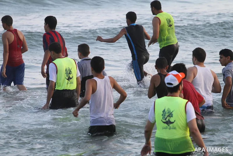 Palestinian boys take part in a training camps of the swimming organized by the Hamas movement into the Mediterranean Sea in Gaza City, on June 6, 2015. Photo by Mohammed Asad
