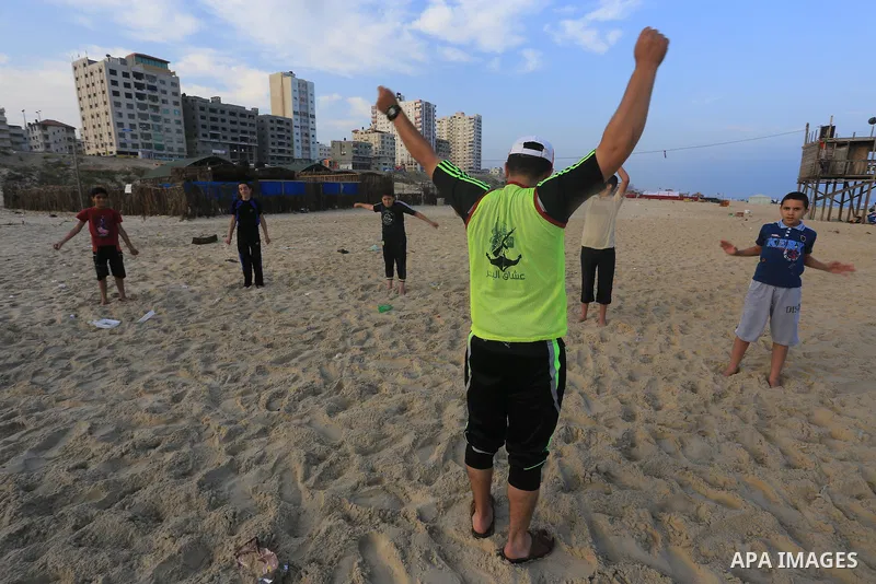 Palestinian boys take part in a training camps of the swimming organized by the Hamas movement into the Mediterranean Sea in Gaza City, on June 6, 2015. Photo by Mohammed Asad