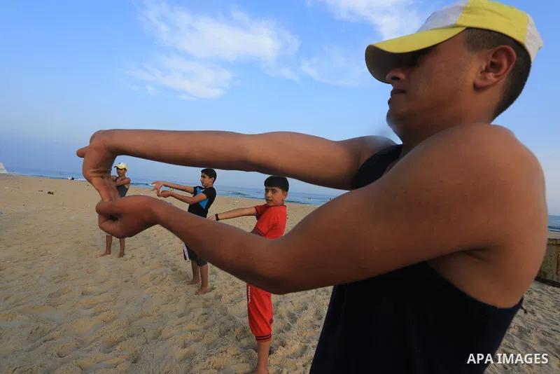 Palestinian boys take part in a training camps of the swimming organized by the Hamas movement into the Mediterranean Sea in Gaza City, on June 6, 2015. Photo by Mohammed Asad