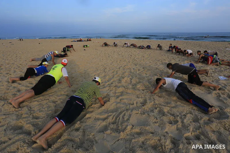 Palestinian boys take part in a training camps of the swimming organized by the Hamas movement into the Mediterranean Sea in Gaza City, on June 6, 2015. Photo by Mohammed Asad