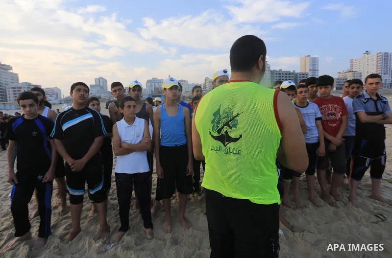 Palestinian boys take part in a training camps of the swimming organized by the Hamas movement into the Mediterranean Sea in Gaza City, on June 6, 2015. Photo by Mohammed Asad