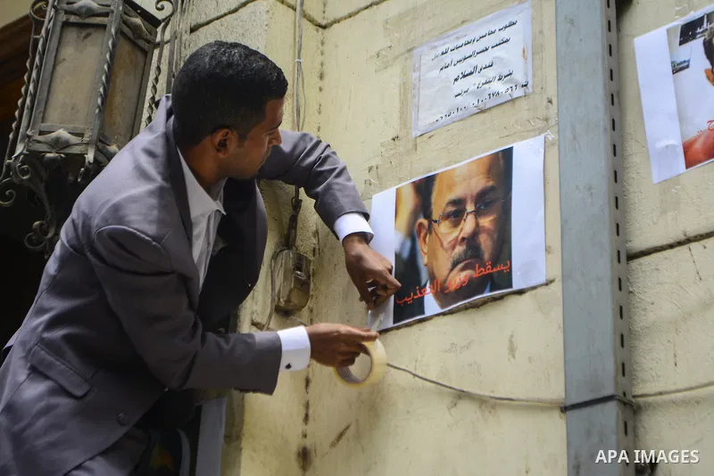 Egyptian lawyers burn pictures of Interior Minister Magdi Abdel Ghaffar, during a protest in front of the syndicate lawyers, Cairo, on June 6, 2015. Photo by Amr Sayed
