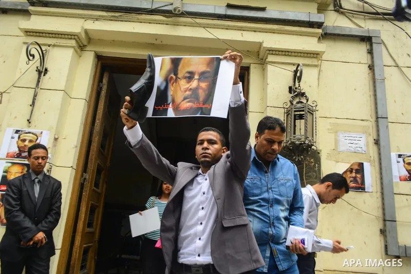 Egyptian lawyers burn pictures of Interior Minister Magdi Abdel Ghaffar, during a protest in front of the syndicate lawyers, Cairo, on June 6, 2015. Photo by Amr Sayed