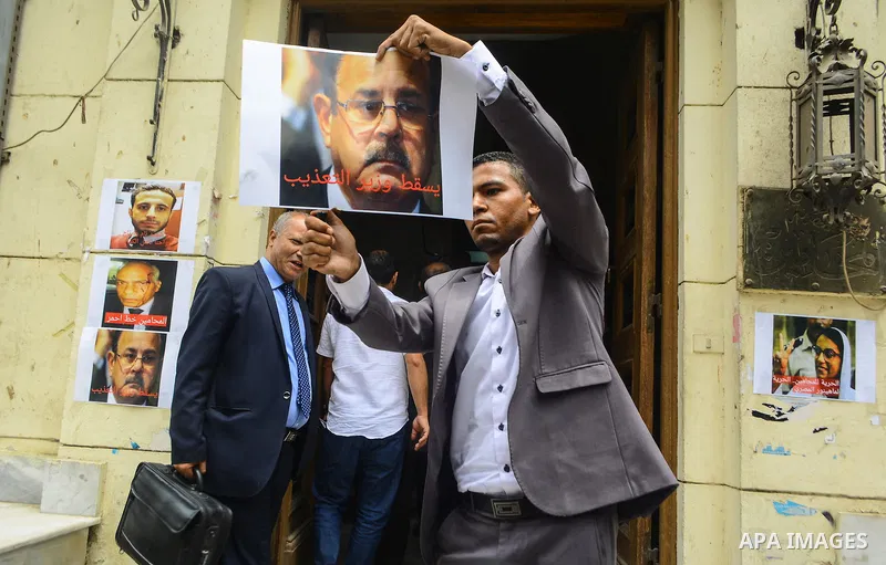 Egyptian lawyers burn pictures of Interior Minister Magdi Abdel Ghaffar, during a protest in front of the syndicate lawyers, Cairo, on June 6, 2015. Photo by Amr Sayed