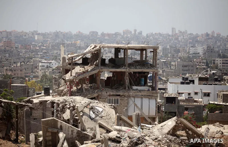 The rubbles of houses, which were destroyed during the 50-day war between Israel and Hamas militants in the summer of 2014, in the Al-Shaaf neighbourhood, on June 06, 2015. Qatar's ambassador Mohammed al-Emadi announced...