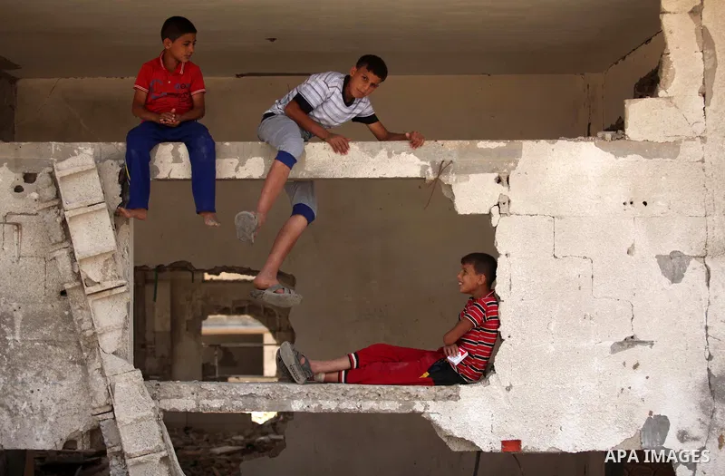 Palestinian children play on the rubble of houses which were destroyed during the 50-day war between Israel and Hamas militants in the summer of 2014, in the Al-Shaaf neighbourhood, on June 06, 2015. Qatar's ambassador M...