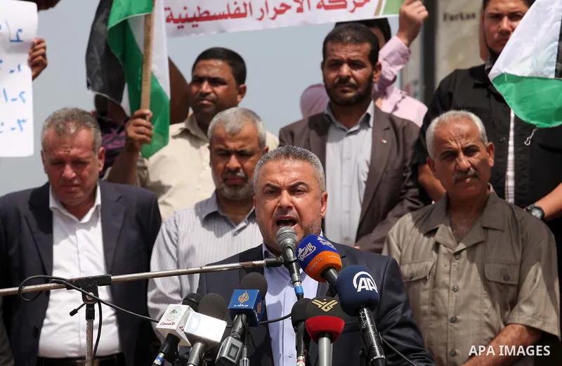 Senior Hamas leader Ismail Radwan speaks during a protest demanding for the opening of a waterway, reconstruction of houses, and to break the siege at the Gaza seaport on March 07, 2015. Photo by Ashraf Amra