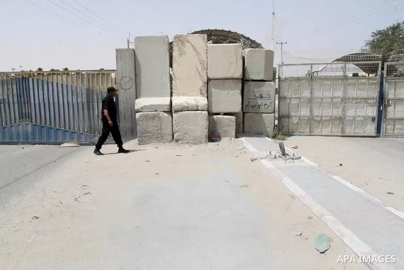 A Palestinian security officer walks past the gate under Palestinian control at the Kerem Shalom crossing between Israel and the southern Gaza Strip, south of Rafah on June 7, 2015 after Israel closed, until further noti...
